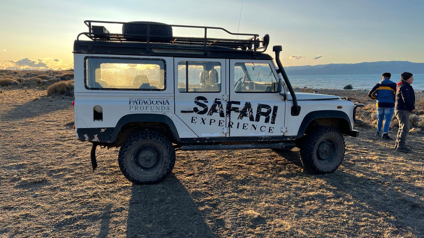 a white vehicle with a rack on top of it
