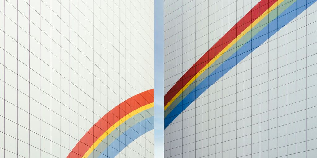 a couple of white walls with a rainbow painted on them