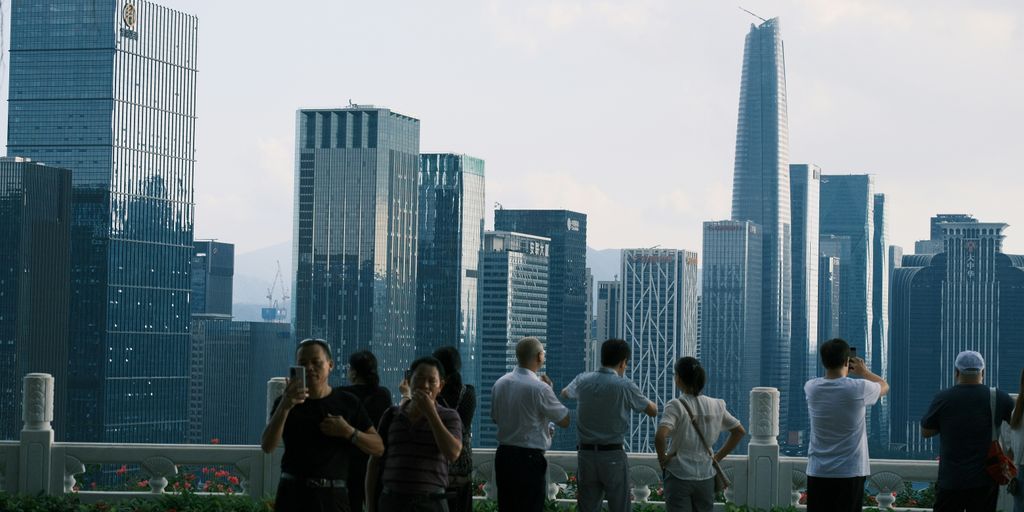 a group of people standing in front of a city skyline