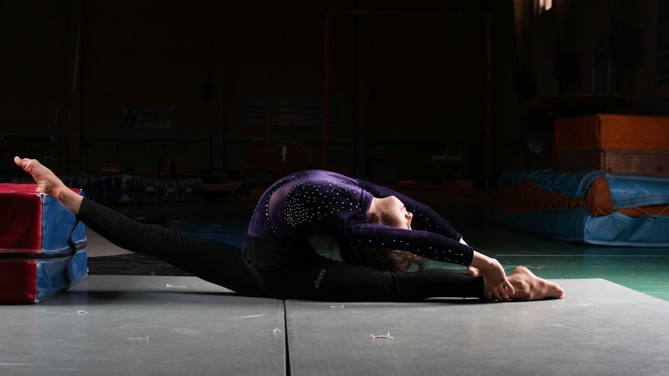 a woman laying on the floor with a suitcase