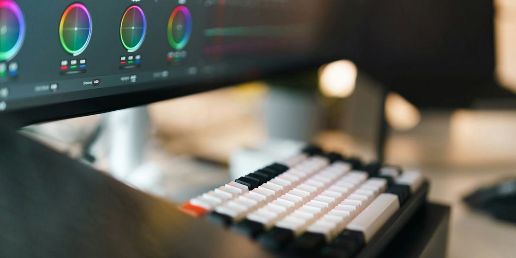 A close up of a computer monitor with a keyboard