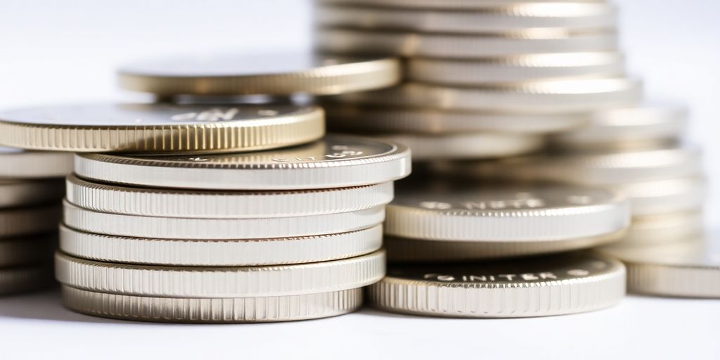 Des pièces d'argent empilées sur une surface élégante.