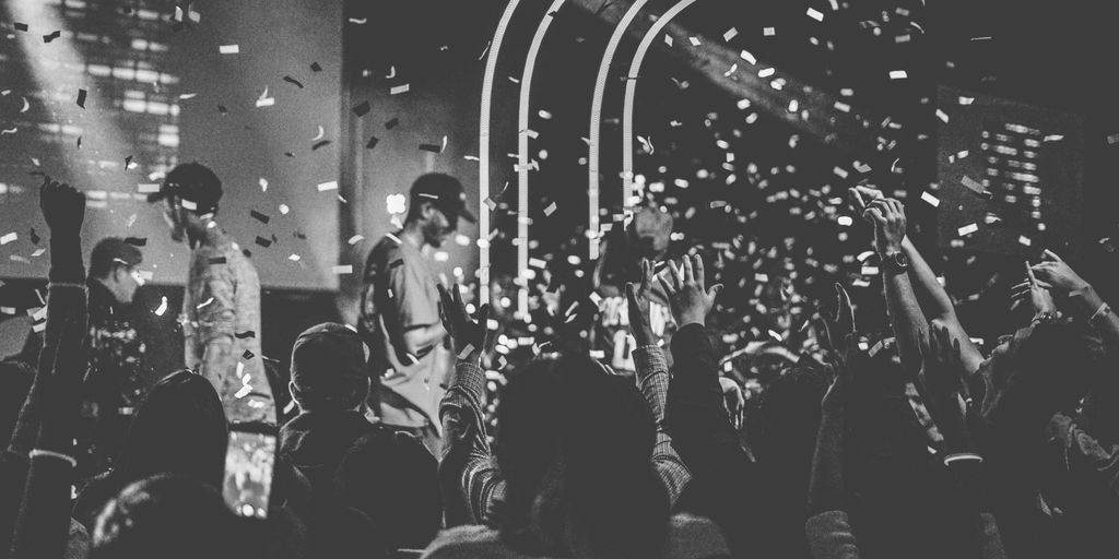 people performing on stage surrounded with people
