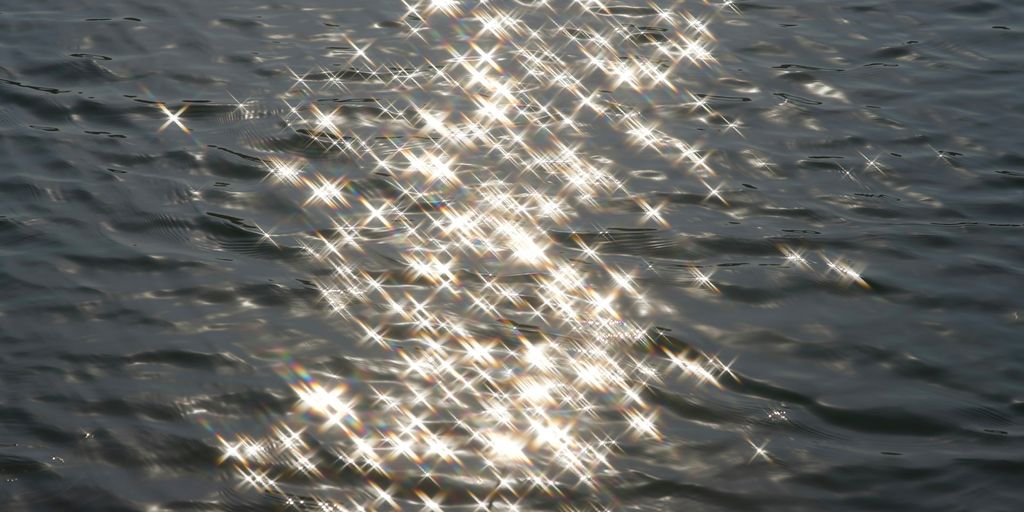 The sun shines brightly on the water