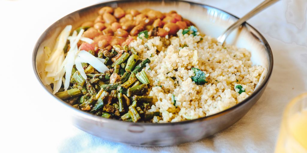 cooked rice with green peas and carrots on stainless steel bowl