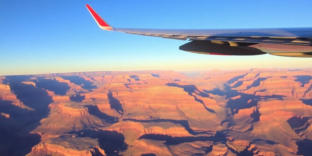 A small airplane flies over the expansive Grand Canyon.