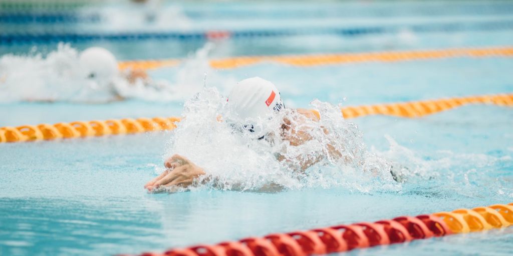 swimmer eating crackers poolside