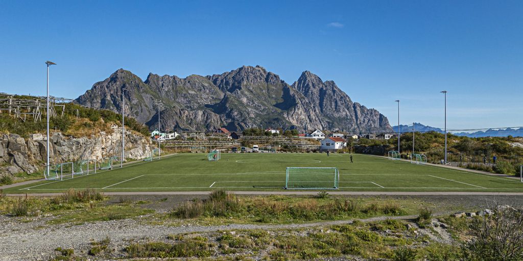 a tennis court with mountains in the background
