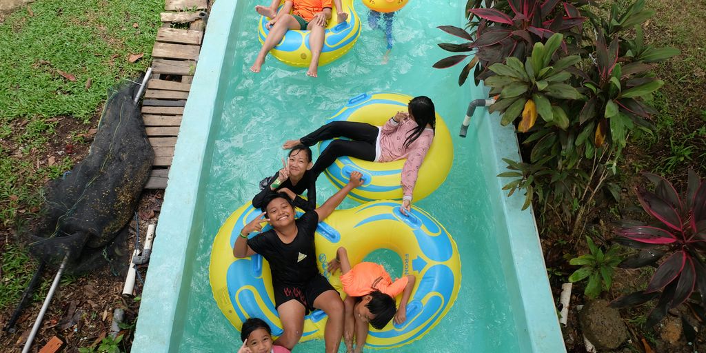 a group of people riding on top of an inflatable raft