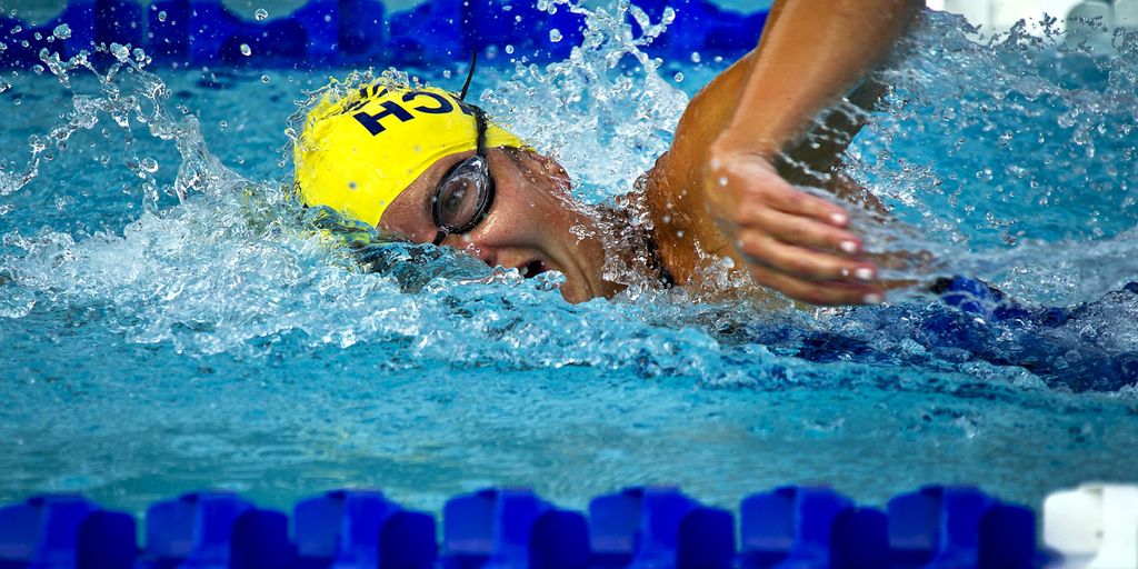 swimmer eating apple poolside