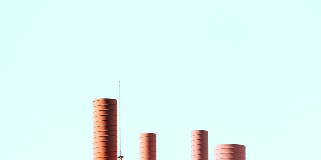 cylindrical brown tanks under blue sky