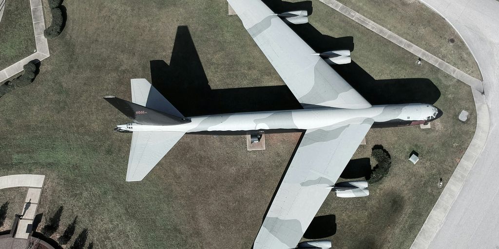 white and black jet plane on green grass field