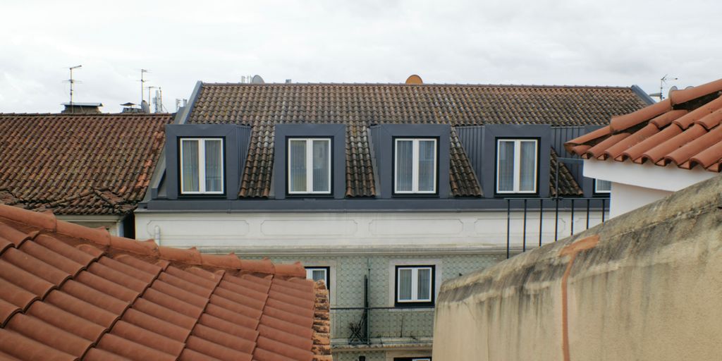 Buildings with tiled roofs and dormer windows.