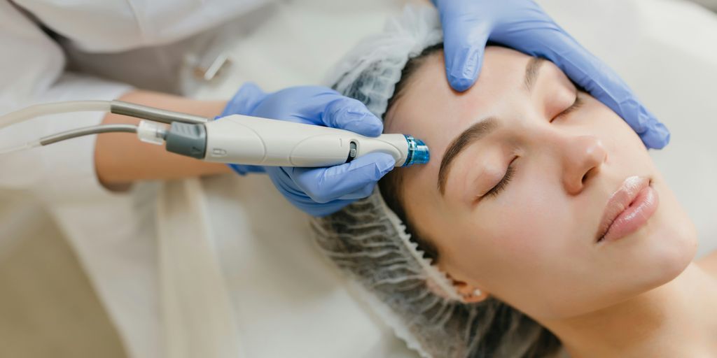 a woman getting a facial peel from a doctor
