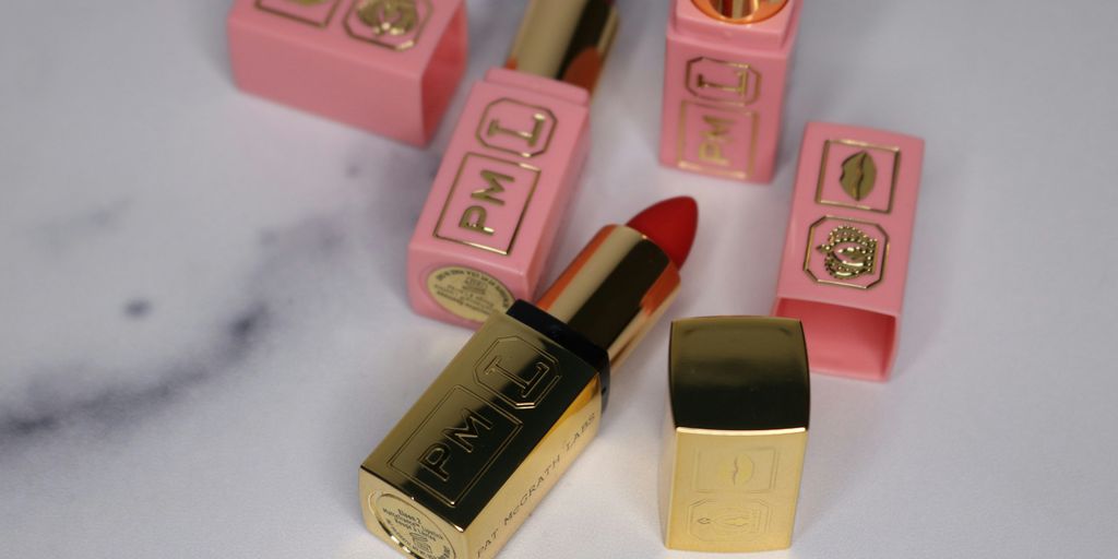 pink and brown lipstick on white table