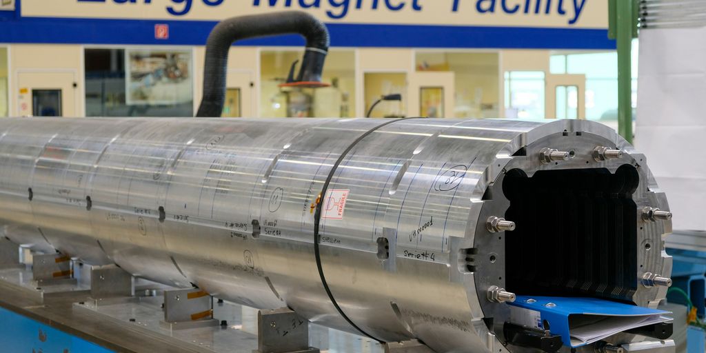 a large metal tube on a machine in a factory