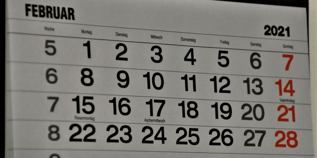 black and white calendar on white wall