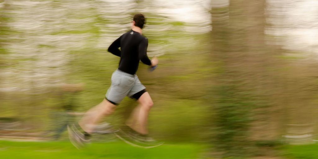 a blurry photo of a man running in a park