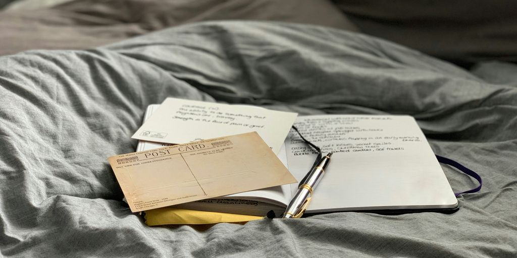 brown and white book on gray textile