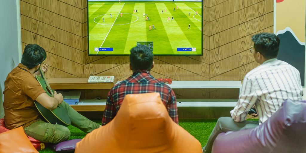 a group of people sitting in front of a flat screen tv