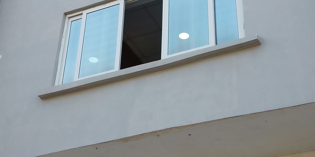 a white building with a window and a light