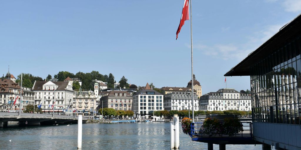 a large body of water with buildings in the background