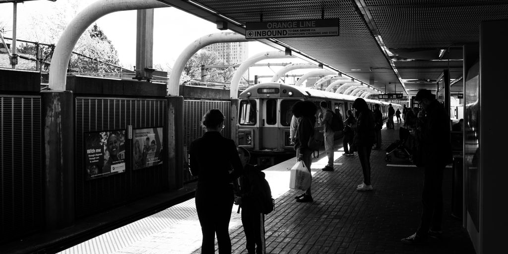 people waiting for the train to stop at the station
