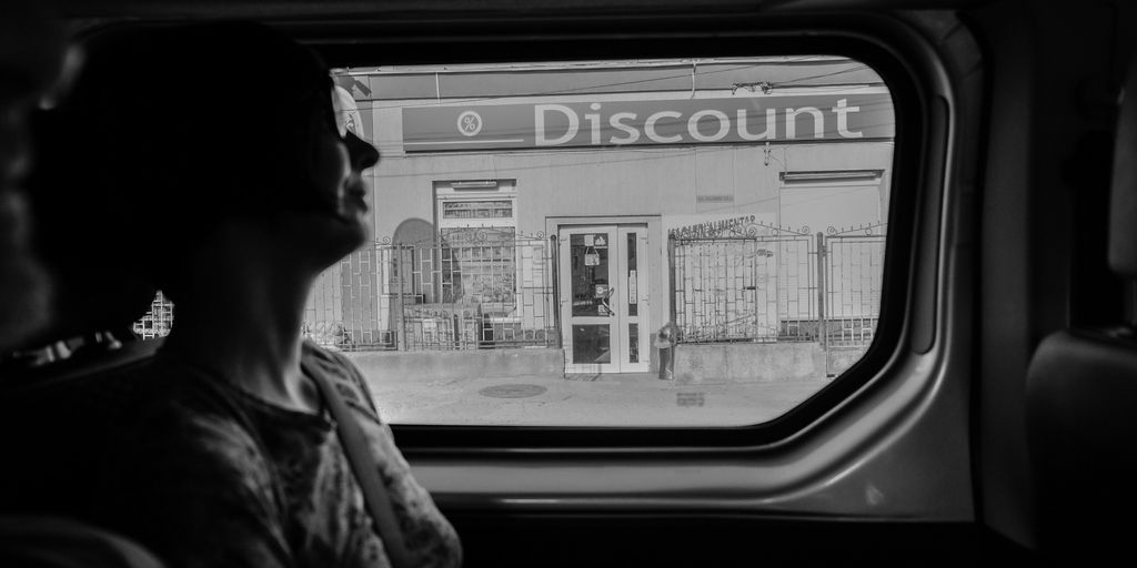 greyscale photography of woman inside vehicle