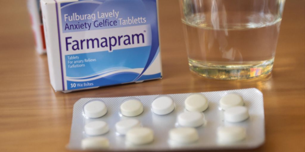 Blister pack of Farmapram pills with glass of water.