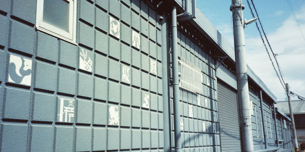 a person walking down a street next to a building