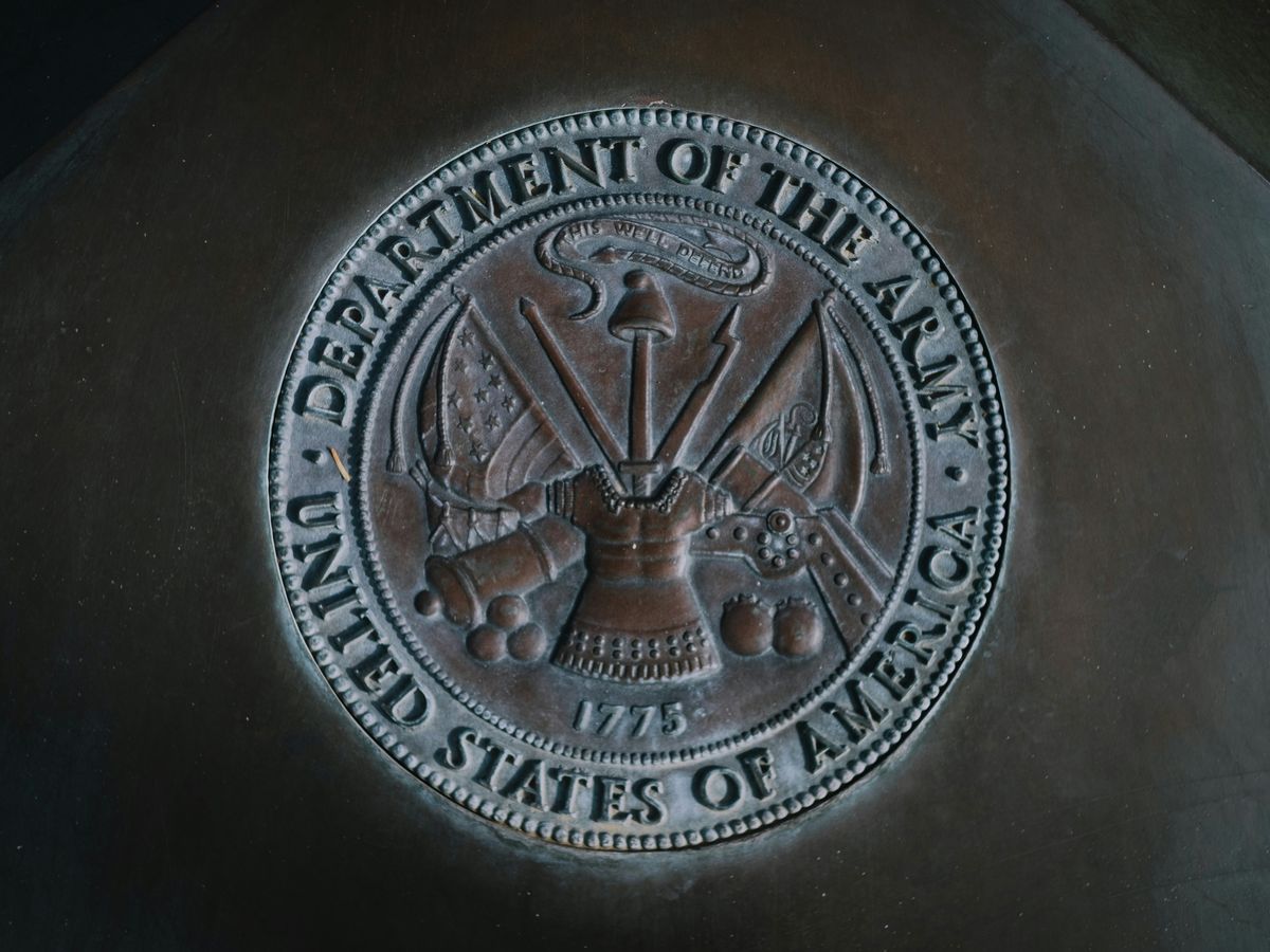 silver round coin on black textile