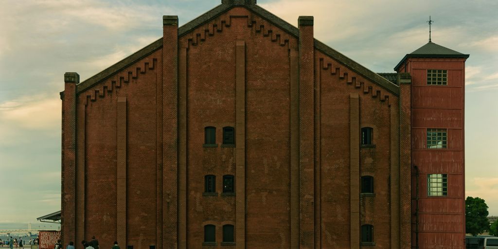 a large red brick building with a clock tower