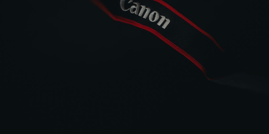 a close up of a canon logo on a black background