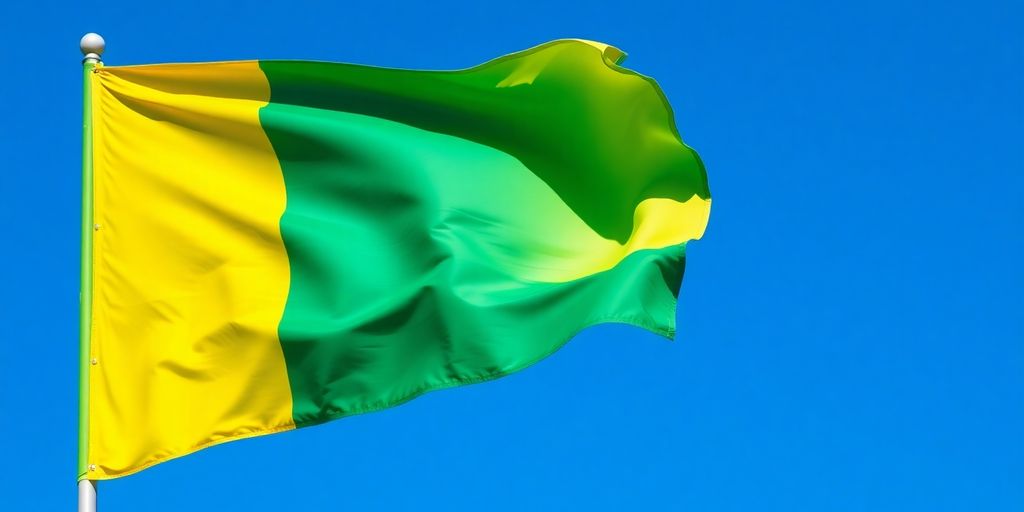 Drapeau gabonais flottant sous un ciel bleu.
