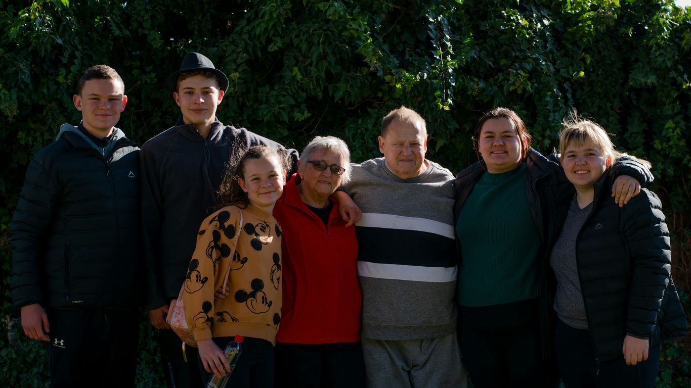group of people standing near green trees during daytime