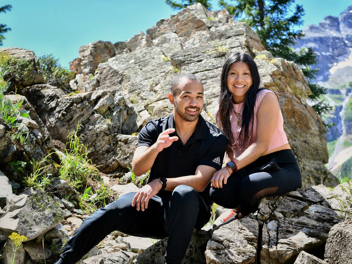a man and a woman are sitting on rocks