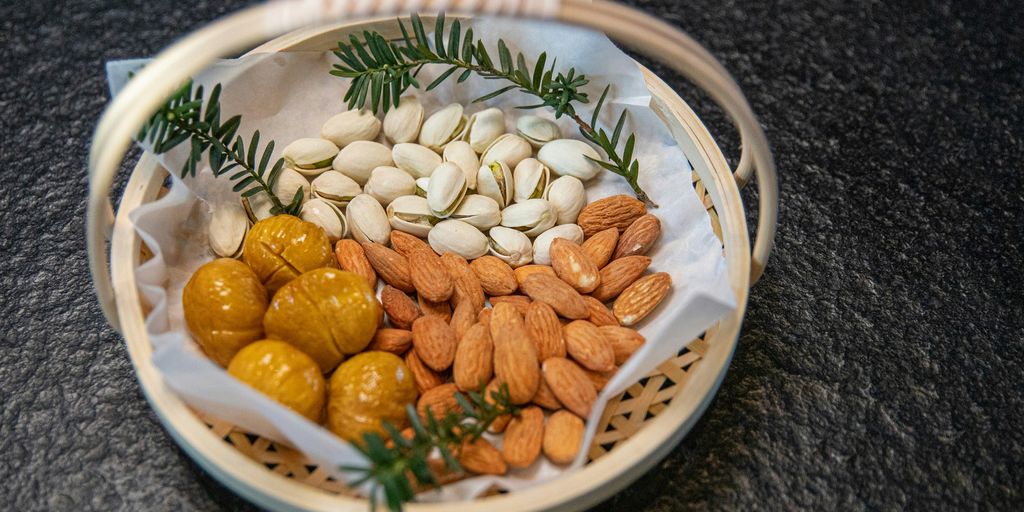 a basket filled with nuts and almonds on top of a table