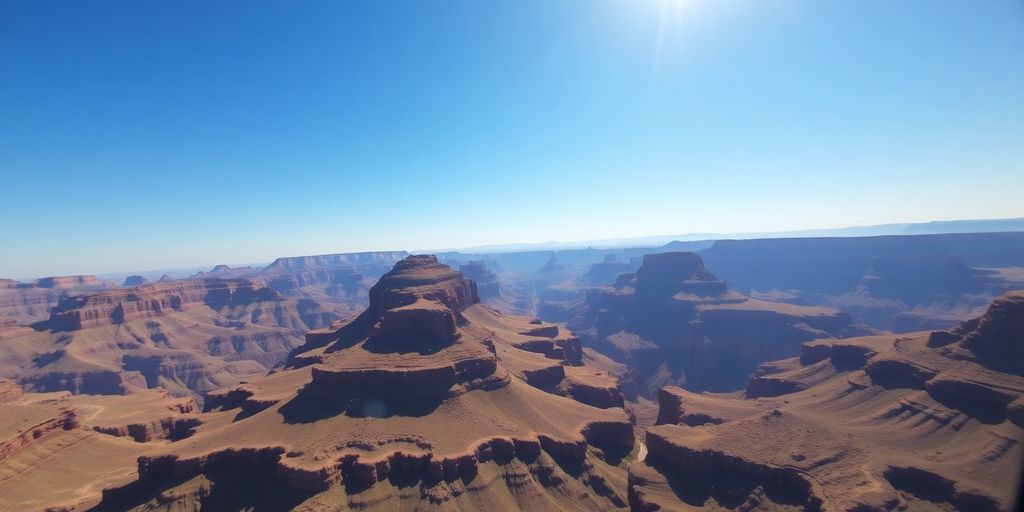 A red helicopter flies over the vast Grand Canyon.