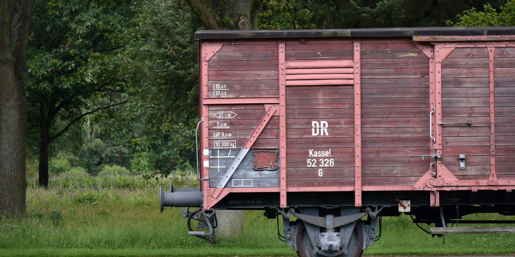 A red train car sitting on top of train tracks
