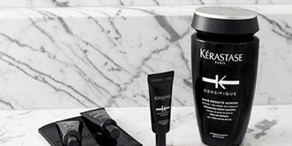 Kérastase hair care products displayed on marble surface.