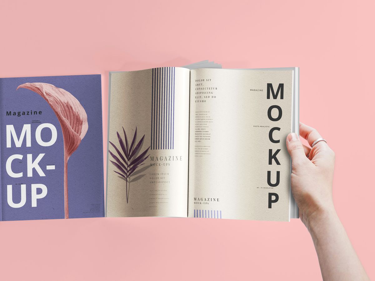 a hand holding a book open to a mockup