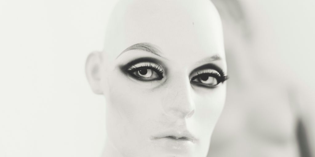 human face with black eyeshadow and mascara