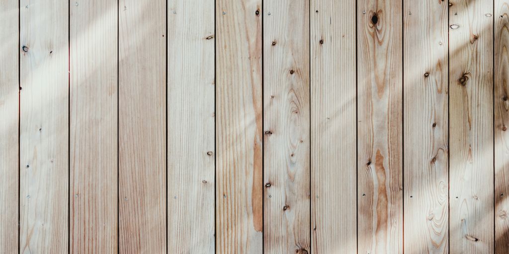 a close up of a wooden wall with a light shining on it