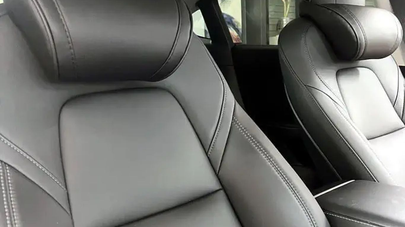 Interior of a modern car featuring sleek black leather seats.