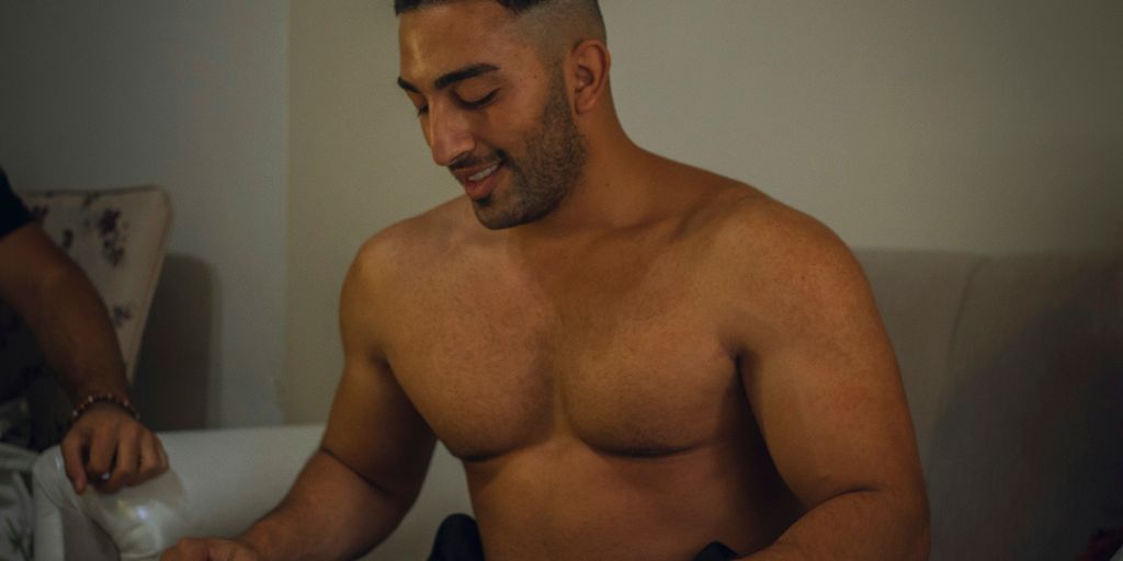 topless man wearing silver watch