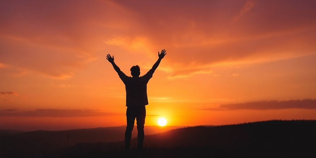 Silhouette on a hill against a sunset sky.