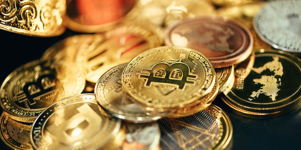 A variety of cryptocurrency coins displayed on a surface.