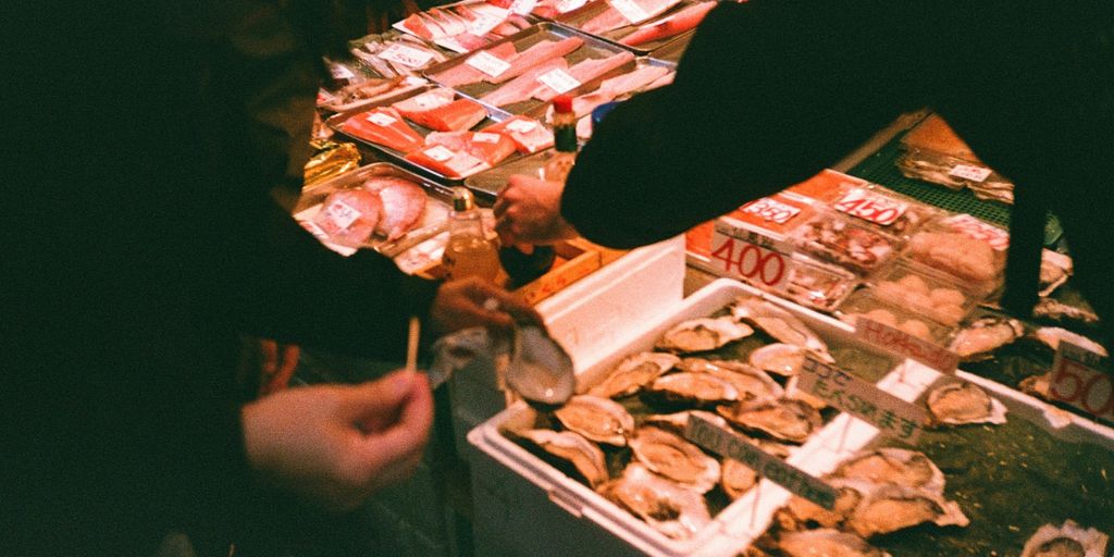 a man standing in front of a table filled with food