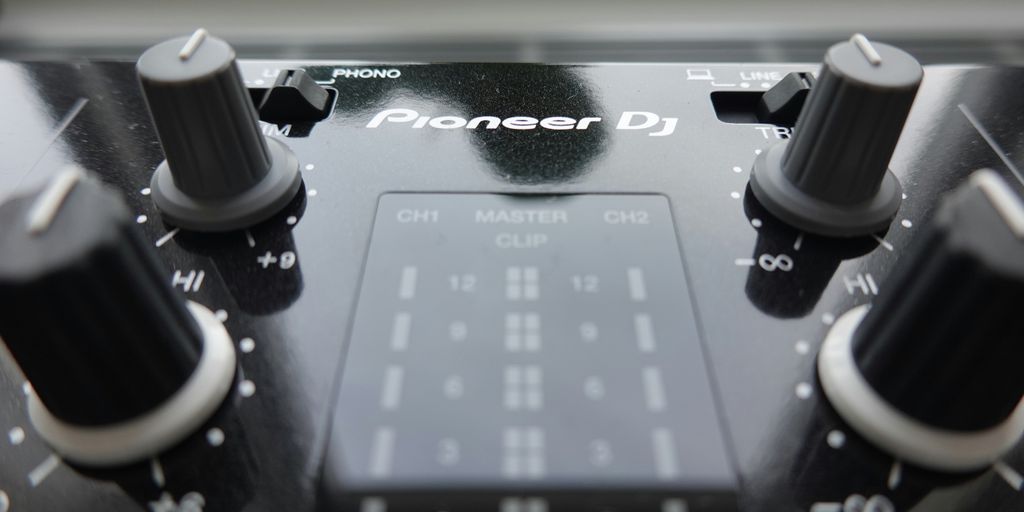 a close up of a sound board with knobs