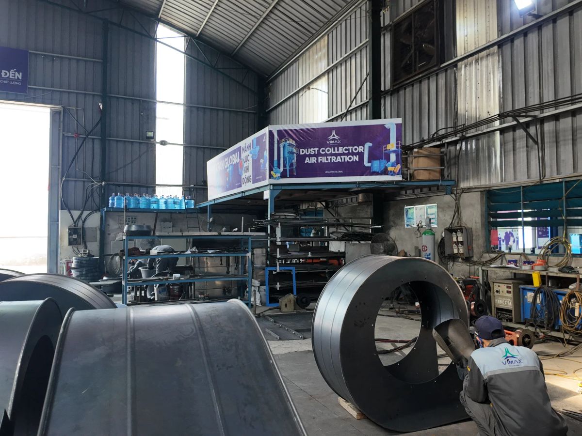 Industrial workshop with machinery and air filtration equipment.